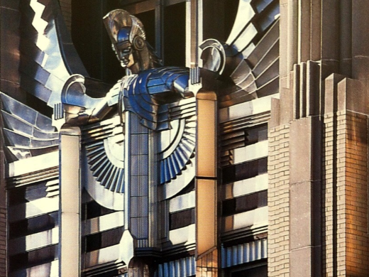 Zoomed in view of a statue on an Art Deco building