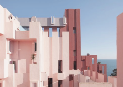 Asymmetric pink and red postmodern building towers