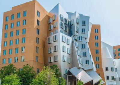 Sharp, asymmetric features of an orange and gray postmodern building