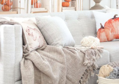 Grey couch with pumpkin decor