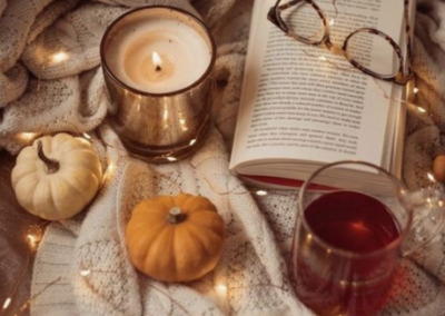 Fall setup with gourds, candle, book and lights