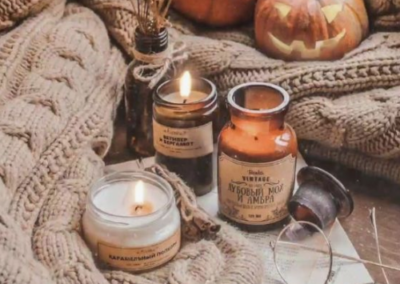 Fall setup with sweaters, candles and pumpkins