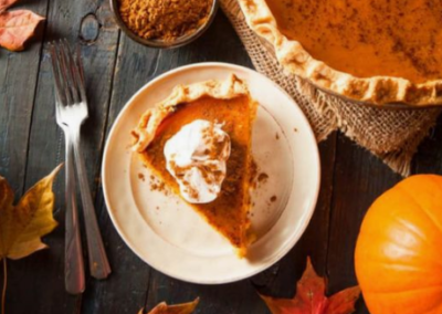 Overhead shot of a slice of pumpkin pie with whipped cream on top