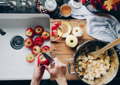 Overhead shot of someone cutting apples into a pot