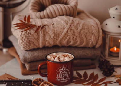 Fall sweaters and a mug of hot chocolate with marshmallows