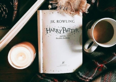 Harry Potter book with candle and hot chocolate