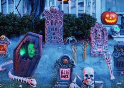 Kitschy Halloween grave and skeleton decorations in a yard