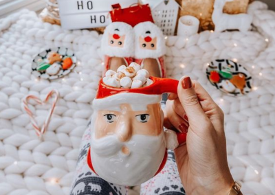 Overhead shot of hot chocolate with marshmallows in a Santa mug