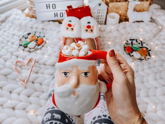 Overhead shot of hot chocolate with marshmallows in a Santa mug