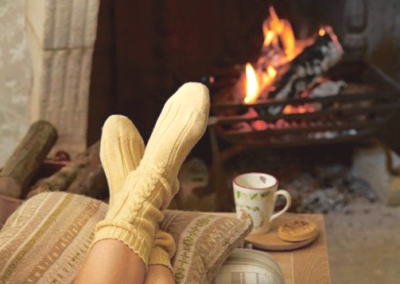 Cozy socks in front of a fireplace