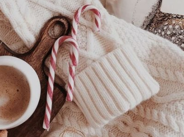 White sweater with candy canes and hot chocolate