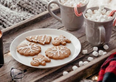 Christmas cookies on a plate with hot chocolate